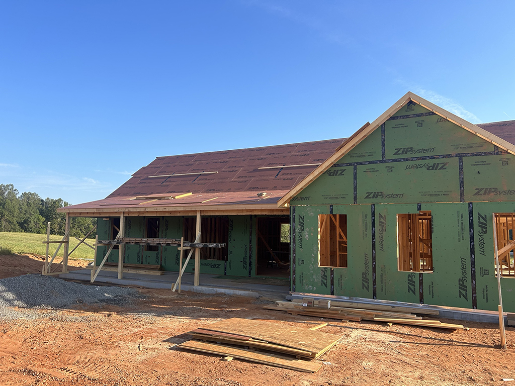 Roof sheathing in progress.