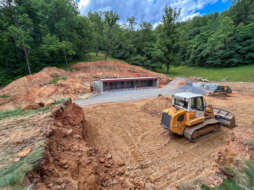 Grading and shell progress for guest house and bermed storage building